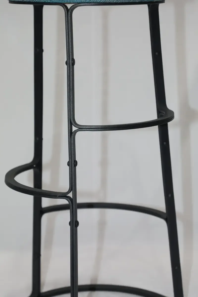 Angled view of the bar stool frame showing the tapered legs and lower ring
