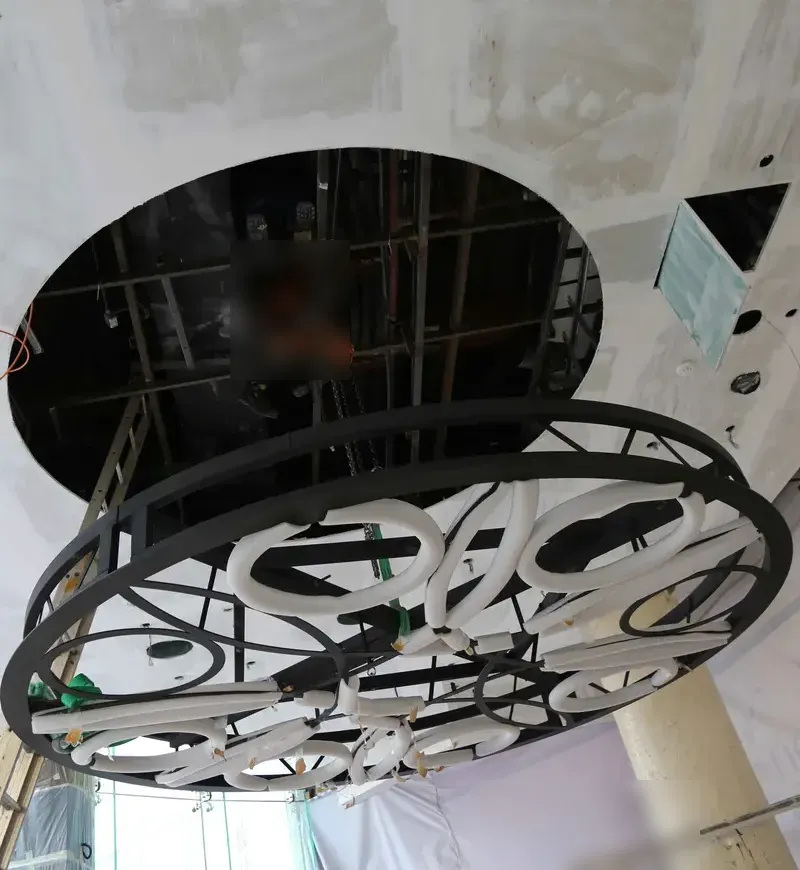 The steel ring hung into a circular ceiling opening with the lighting tubes fitted inside the frame
