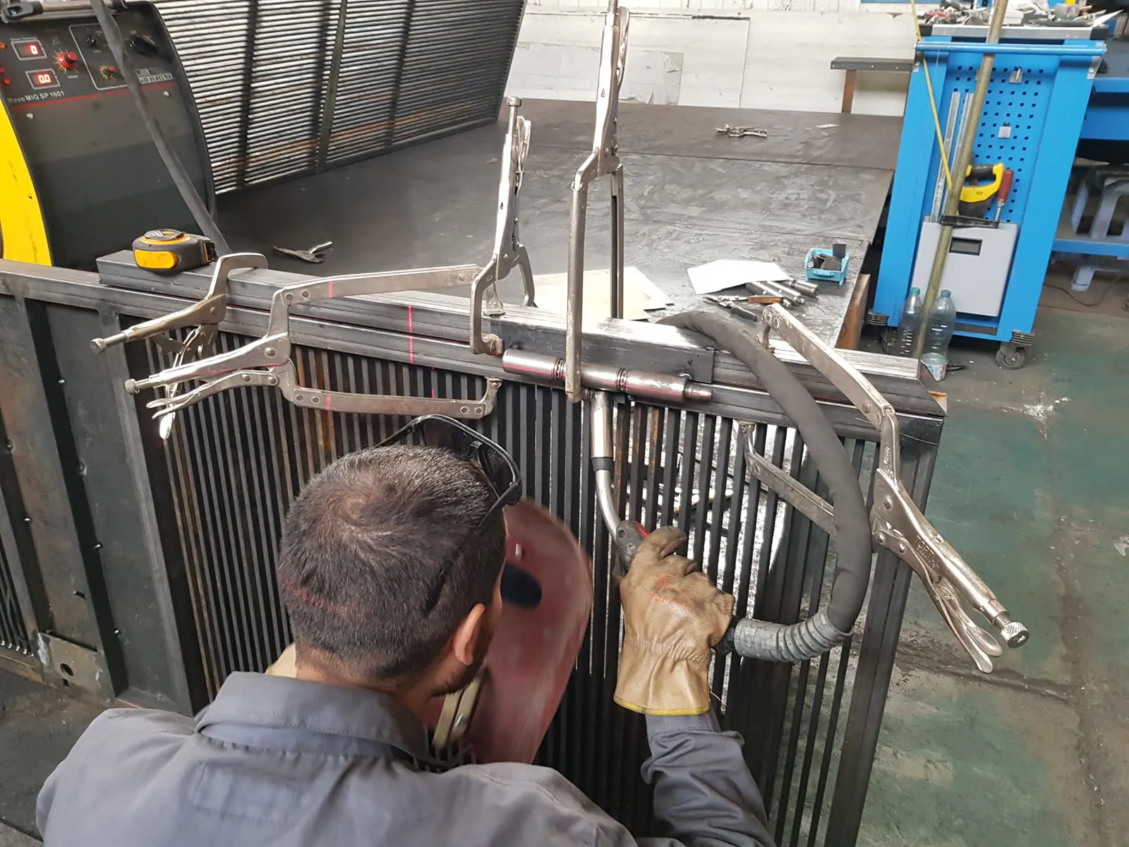 TrussMetal fabricator MIG welding a steel frame in the shop