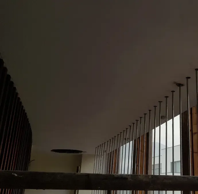 Row of soffit anchor points with the wire ropes hanging from each one
