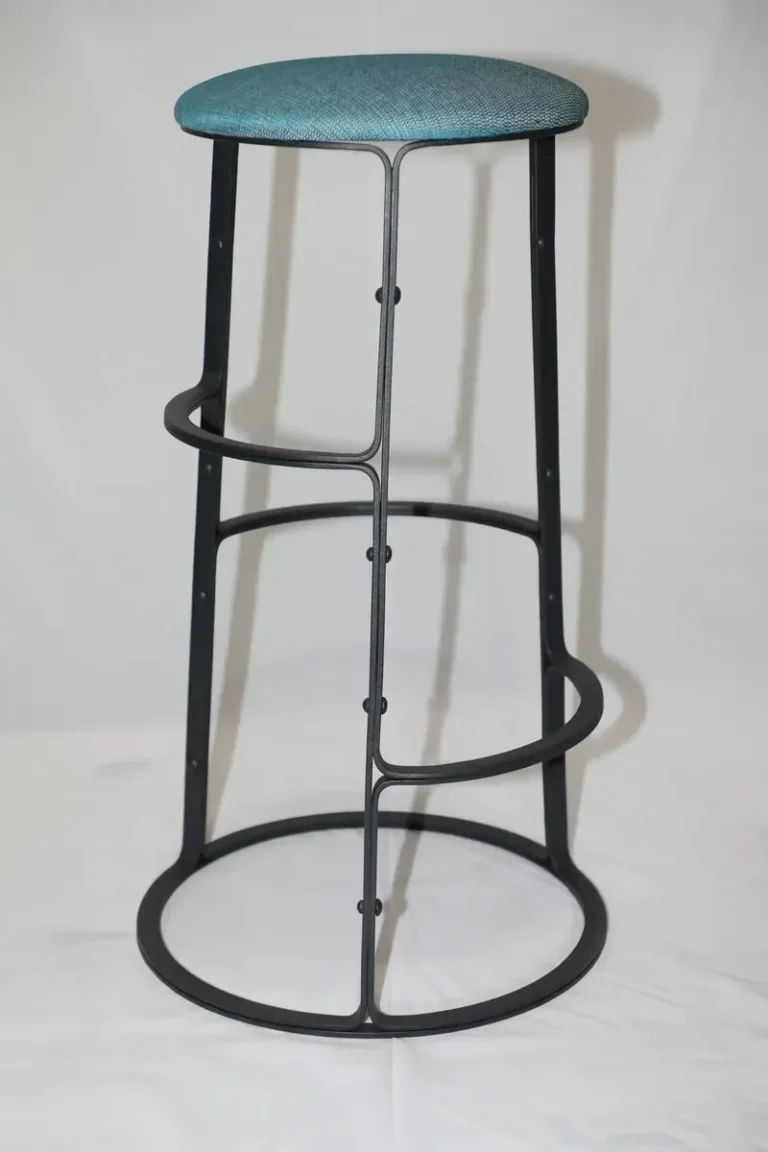 Tall black steel bar stool with a round upholstered seat and a hooped foot ring