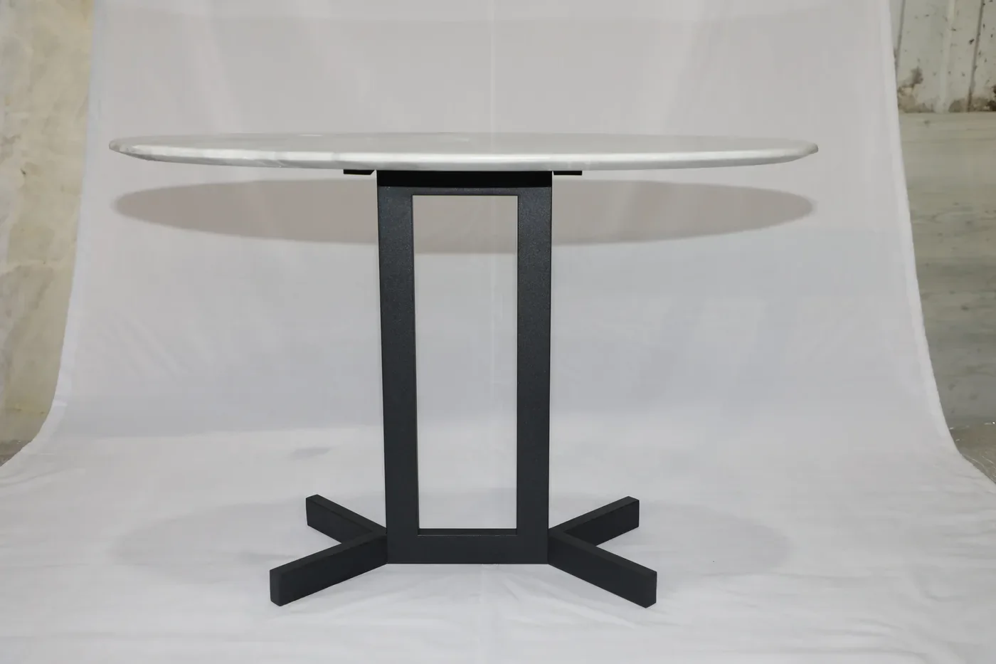 Close detail of the square tube upright and the matte black finish on the steel table base