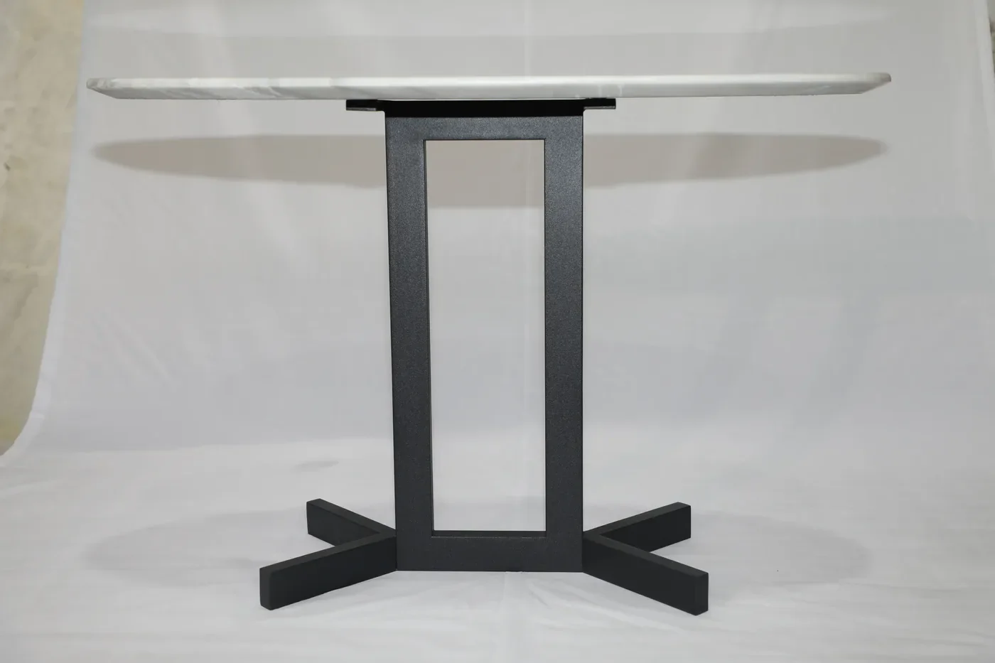 View under the marble top showing the top plate and the steel frame connection