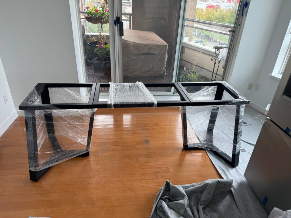 Welded steel table base showing twin trapezoidal pedestals and a central spine
