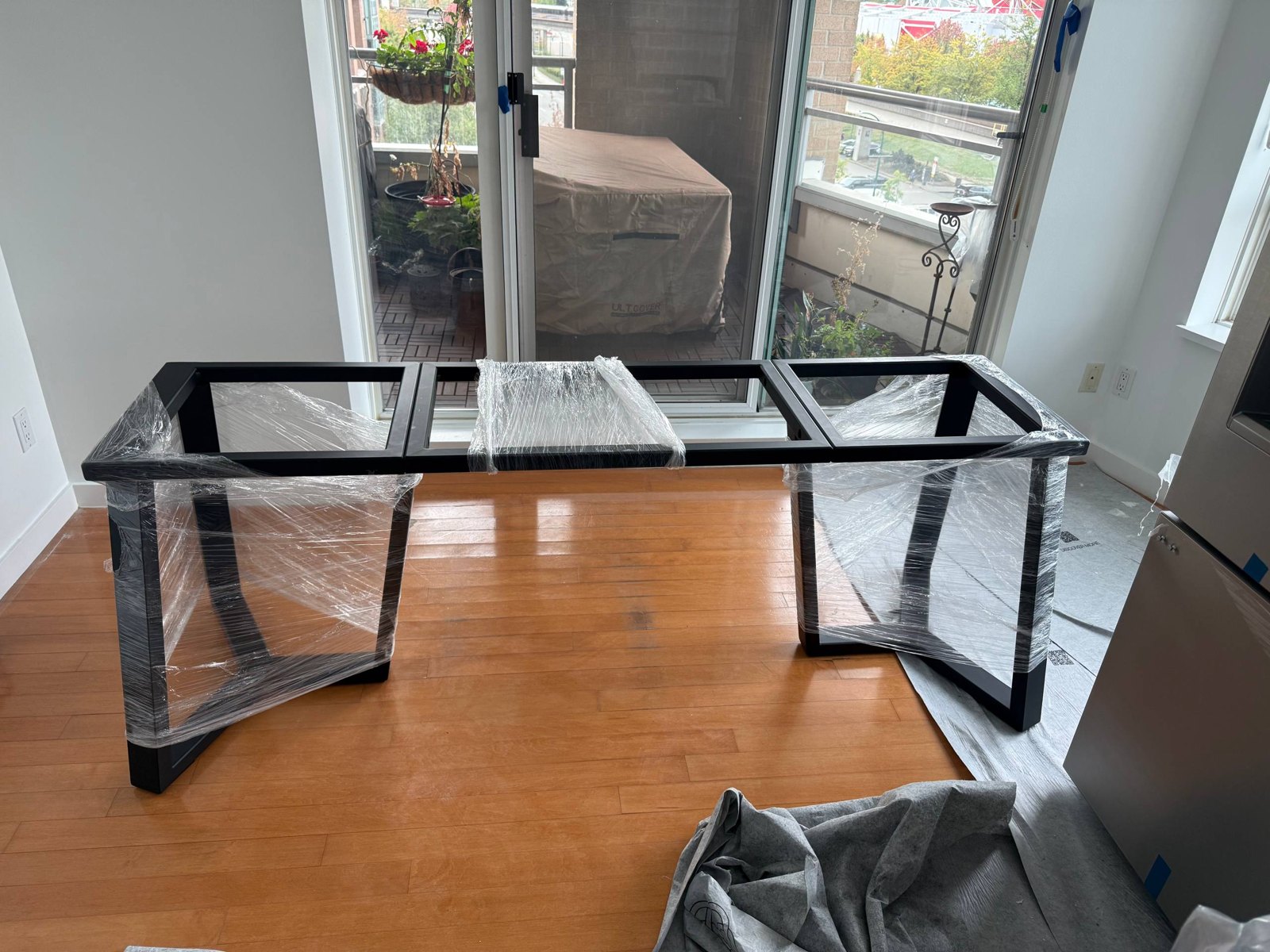 Welded steel table base front view showing twin trapezoidal pedestals and a central spine, matte black